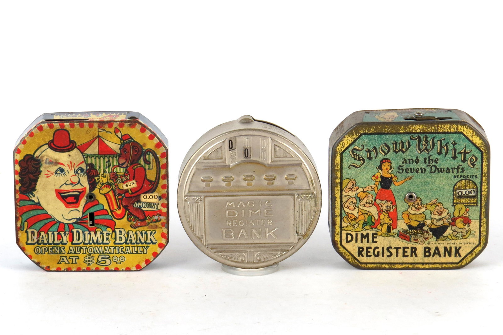 Lot of 3 Dime Register Banks: 3 Dime Register Banks, Tin: Clown "Daily Dime Bank"; "Magic Dime Register Bank"; "Snow White Dime Register Bank"