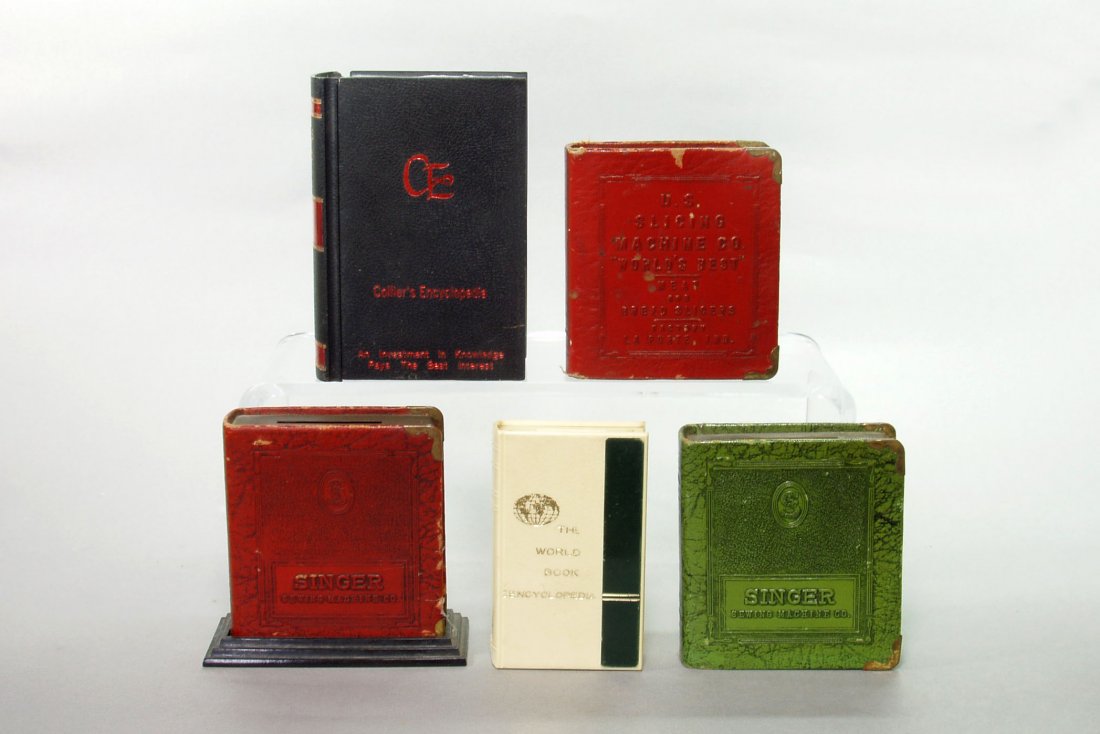 Lot of 5 Adv. Book Banks: Collier's Encyclopedia;: Lot of 5 Adv. Book Banks: Collier's Encyclopedia; World Book Encyclopedia; US Slicing Machine; (2) Singer Sewing Machine - P / V / SM