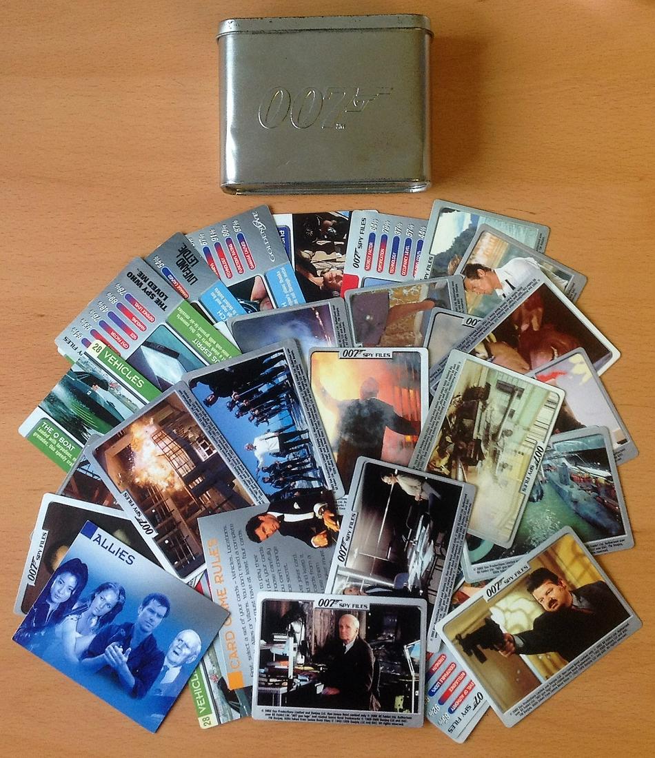 James Bond trading card collection 52 cards featuring: James Bond trading card collection 52 cards featuring Villains, Allies, Gadgets and Vehicles from Bond Films through the years housed in an commemorative 007 Tin signs of age on tin. Good condition. A