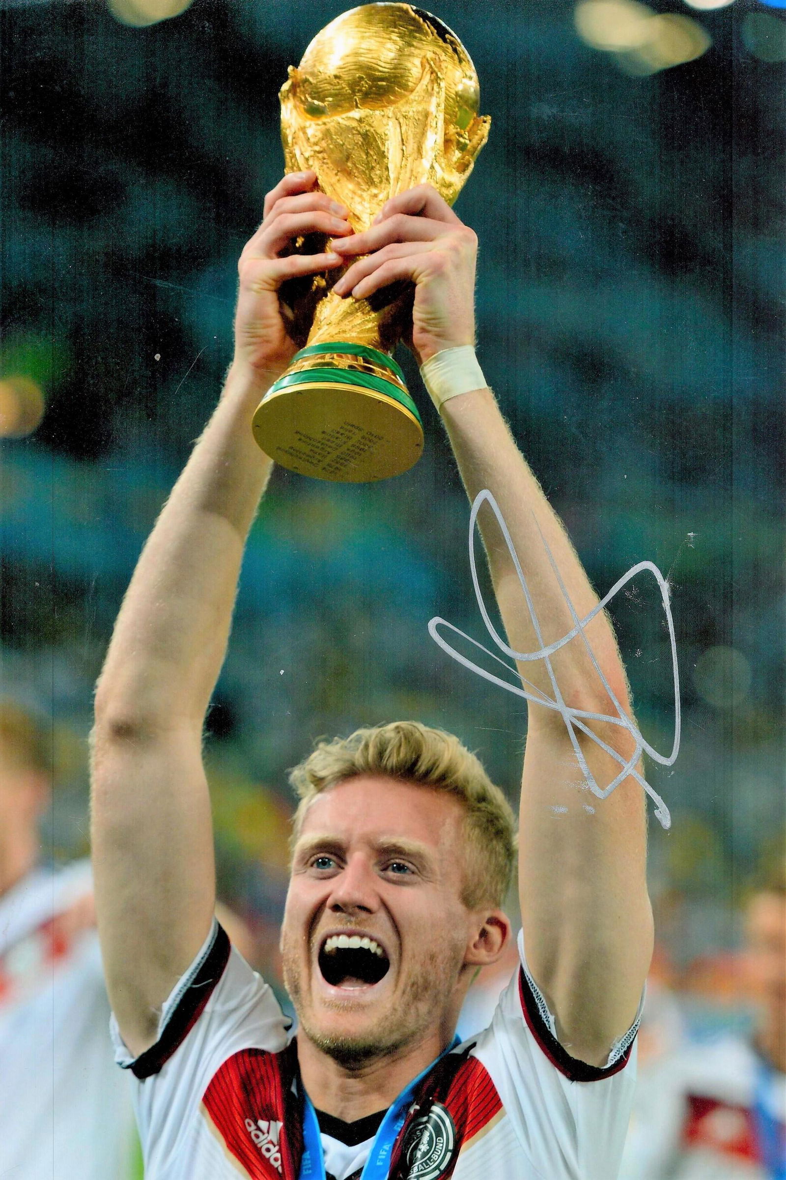 Andre Schurrle signed 12x8 colour photo pictured lifting the World Cup