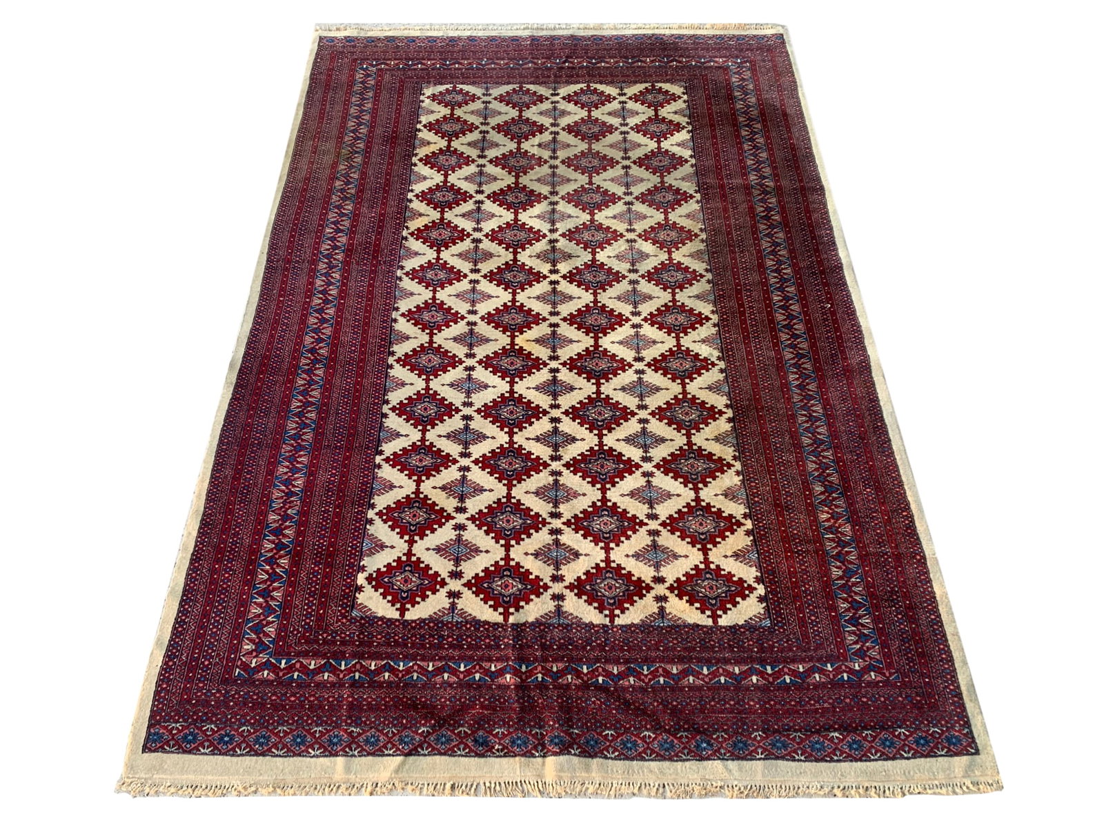 6X9 Ivory Estate Rug, Circa 1980: Hand-knotted wool pile on a cotton foundation. Circa 1980 Dimensions: 6'2" x 9'3" Origin: Pakistan Condition: Fair for its age Field Color: Ivory Border Colors: Burgundy Accent Colors: Royal, Pink SKU