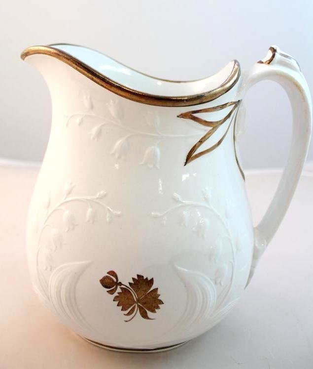 Anthony Shaw Staffordshire Tea Leaf Pitcher: A gorgeous antique 19th Century English Staffordshire Tea Leaf pattern pitcher. With relief molded floral design Made by Anthony Shaw company. Circa 1860-188. Measures 8" by 7" by 5".