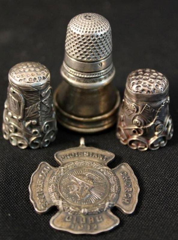 sterling thimbles & 1912 sterling pendant lot: a set of two vintage Sterling silver filigree style thimbles a sterling silver antique thimble with thimble case & a 1912 Protestant sterling silver club pednant.