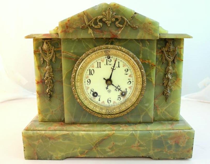 Antique Ansonia green marble mantle clock: gorgeous antique marble mantle clock. In a great green marble. Made by the Ansonia clock company. Porcelain painted dial. Ormolu mounted scroll and floral on top and sides. Measures 12 by 101-/2” by