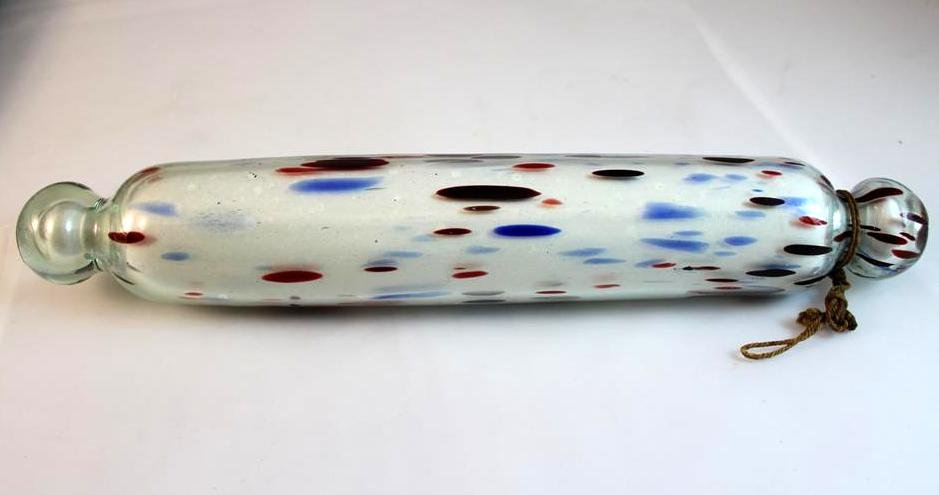 Antique end of day blown glass rolling pin: a great antique 19th Century free form blown glass rolling pin. Cased clear with red & blue spotted over white interior. Partial original string attached still on one end. Measures 13” long