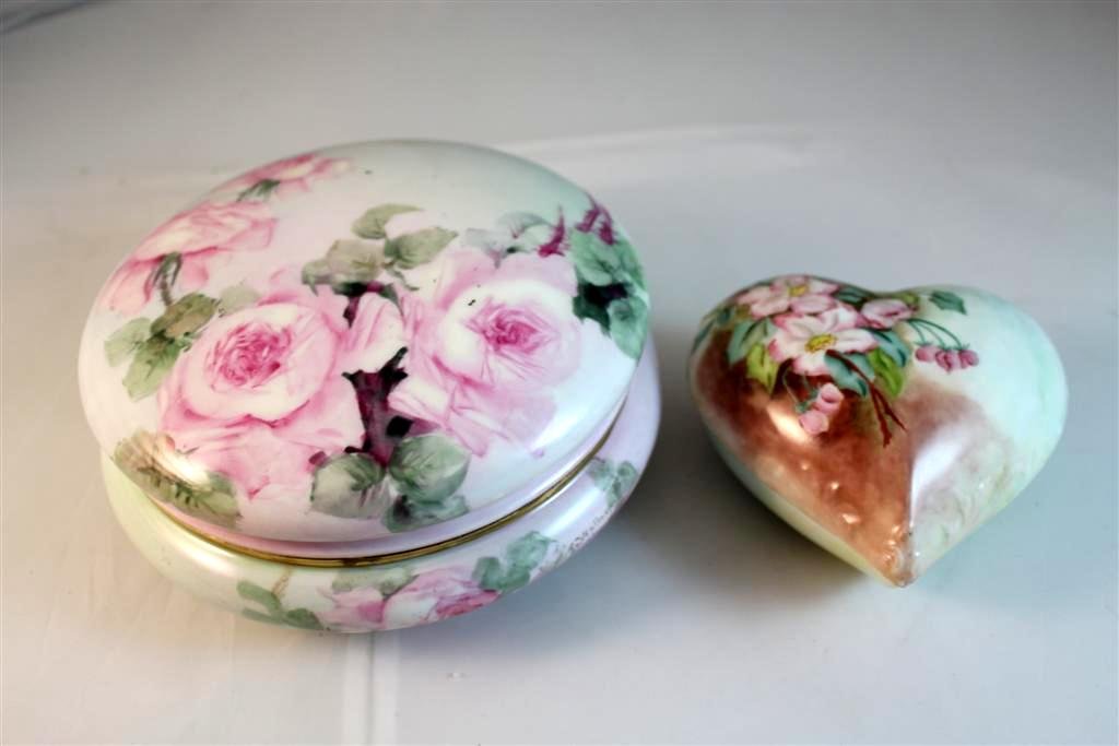 Pair of Limoges painted powder dresser boxes: large hand painted and artist signed T&V limoges round powder box measures 7” diameter. Smaller heart shaped antique limoges painted box. Inscribed by artist and dated 1909.