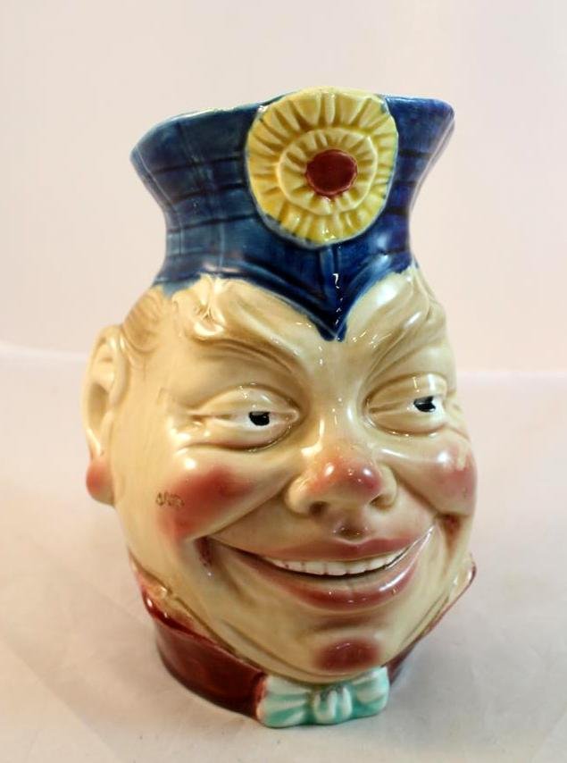 Sarreguemines Majolica Face Head Jug Pitcher: antique Sarreguemines pottery Majolica face jug. Military type figural head with handle. Nice coloring. Unmarked 7-1/2" by 6-1/2" by 5"