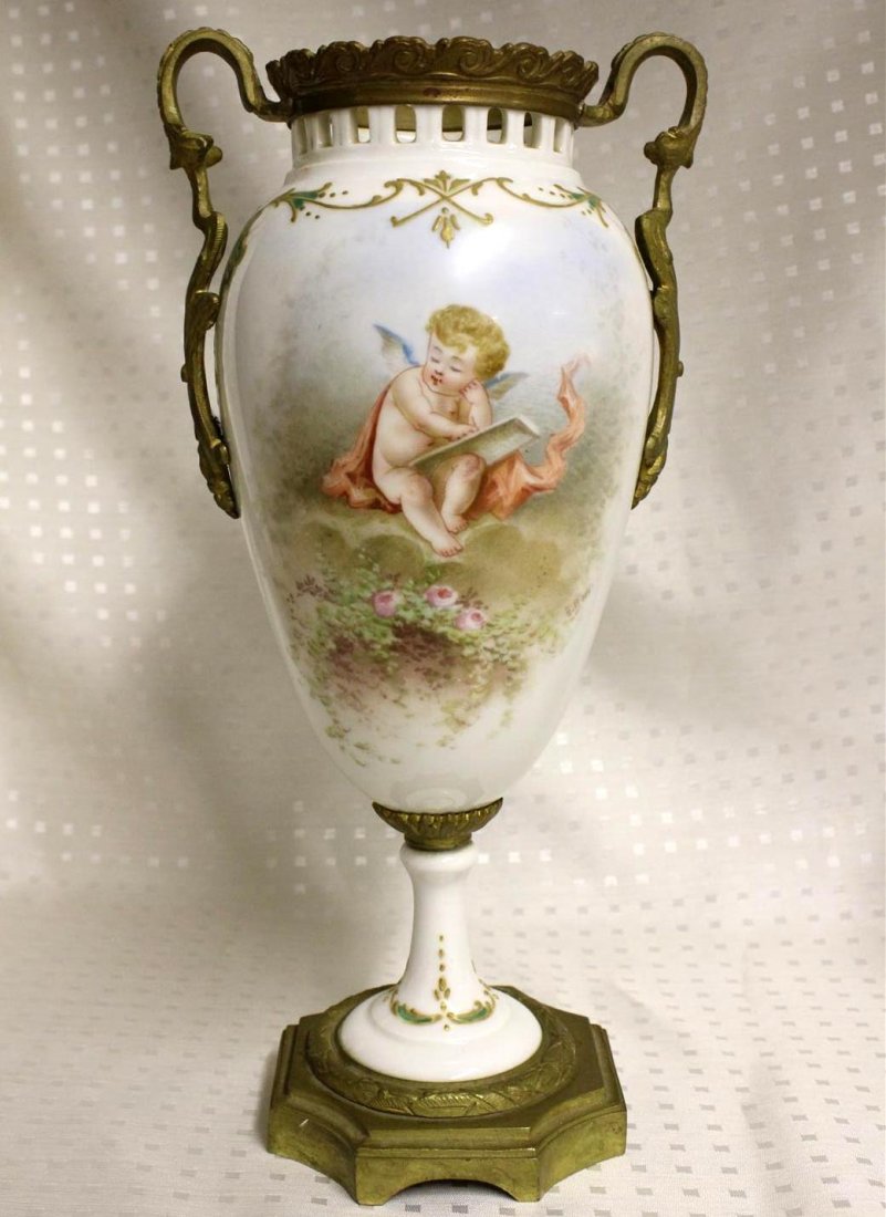 Antique French Sevres Style Ormolu Mounted Vase Cherub: Wonderful antique 19th Century French ormolu mounted porcelain vase. Possibly Sevres, definitely in the style of. Painted with a front scene of a blue winged cherub sitting on the ground with a red ca