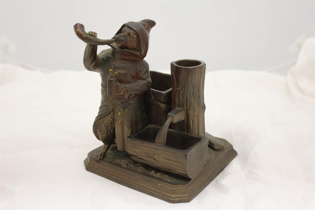 Bohemian FGW Figural Terracotta Cigarette Match Holder: Figural Wolf wearing cloak blowing horn holding stein. Standing next to log & Trough. Marked on the bottom FGW most likely for the Bohemian company Ferdinand Gerbing. Made of Brown painted Terracotta 