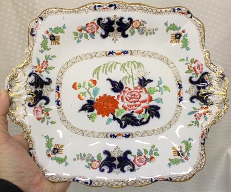 1844 Minton New Stone Gaudy Dutch style Serving Plate: Nice antique 1844 Minton English Ironstone Handled Serving Plate. Designed in the Gaudy dutch style polychrome colors and flowers. Marked on the back with a stamped cartouche with no 6034 written by h