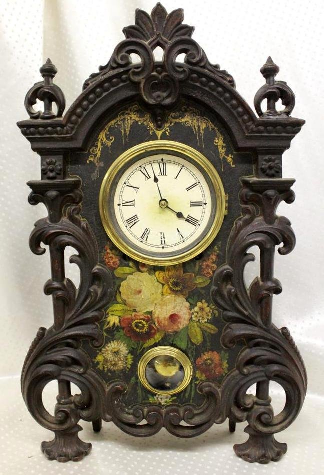 Antique Gothic Style Cast Iron Painted Mantle Clock Man: Very ornate Antique 19th Century mantle clock. Front made of Cast Iron black finished with hand painted flowers on the center. Back case is wood mounted to the cast iron. No makers mark. In working co