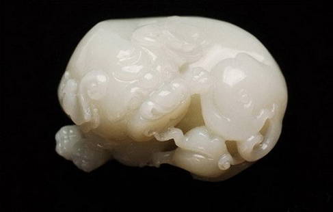 A Fine White Jade Carving: A Fine White Jade Carving with mythic animal motif , Qing Dyansty , size: 8.6 X 4.3 CM