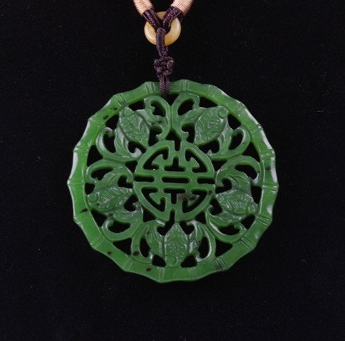An Old Spinach Jade Plaque: An Old Spinach Jade Plaque with Shou Character motif surrounded by bats, late Qing period ,size : 5.1 X 0.5 CM