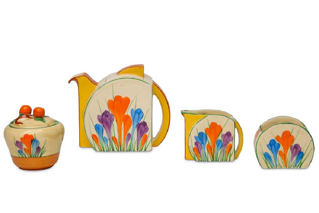 A CLARICE CLIFF 'CROCUS' PATTERN PART BREAKFAST SET: A CLARICE CLIFF 'CROCUS' PATTERN PART BREAKFAST SET, circa 1931-34, in Stamford shape, comprising a teapot and cover, a cream jug, and a sugar bowl, together with a 'Crocus' pattern preserve pot and c