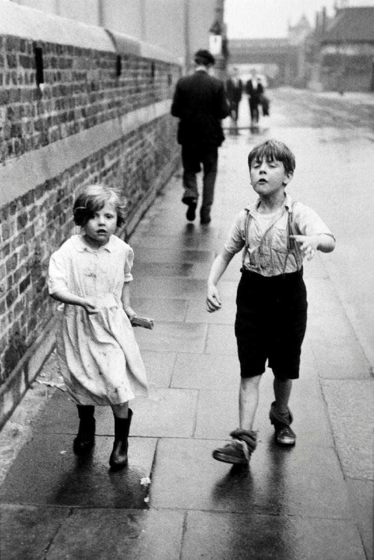 Thurston Hopkins 1913-2014: Thurston Hopkins 1913-2014 FROM A STORY ON CHILDREN OF THE PAVEMENTS, BATTERSEA, 1954, silver gelatin print, printed later, image size 374mm x 253mm, titled, dated and signed by the photographer in pe