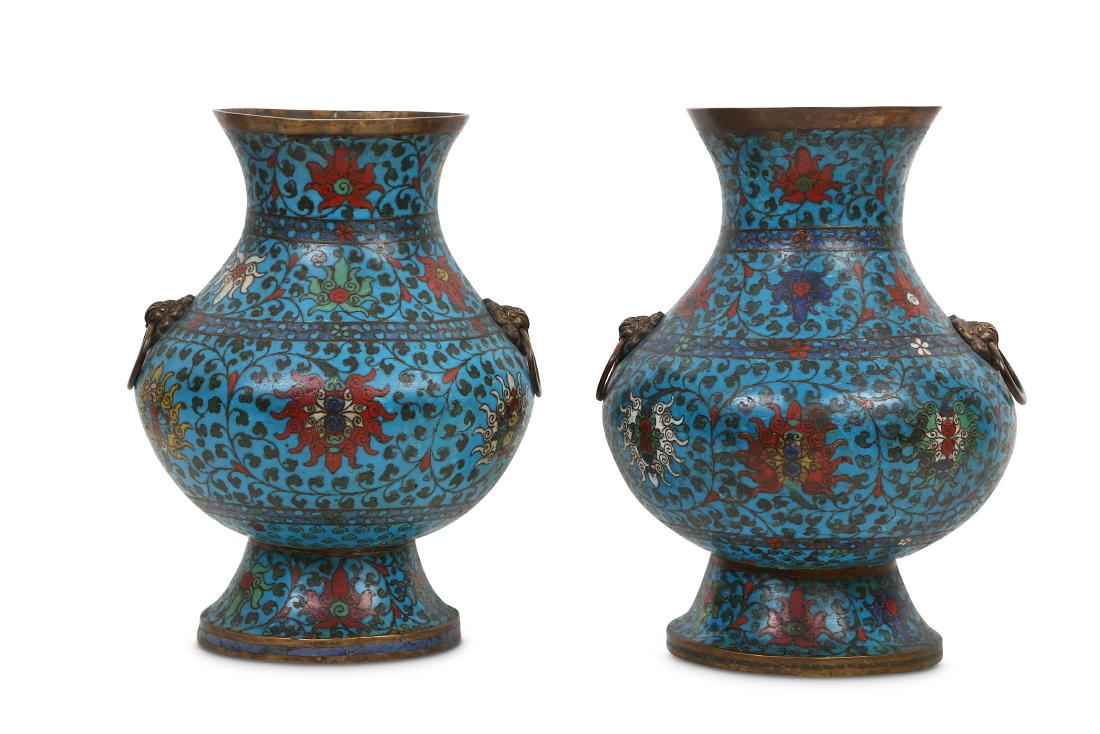 A PAIR OF CHINESE CLOISONNE VASES, HU.: A NEAR PAIR OF CHINESE CLOISONNÉ VASES, HU. Ming Dynasty. Each with a pear-shaped body rising to a flared neck, decorated with rows of colourful lotus flower heads between floral bands all on a b