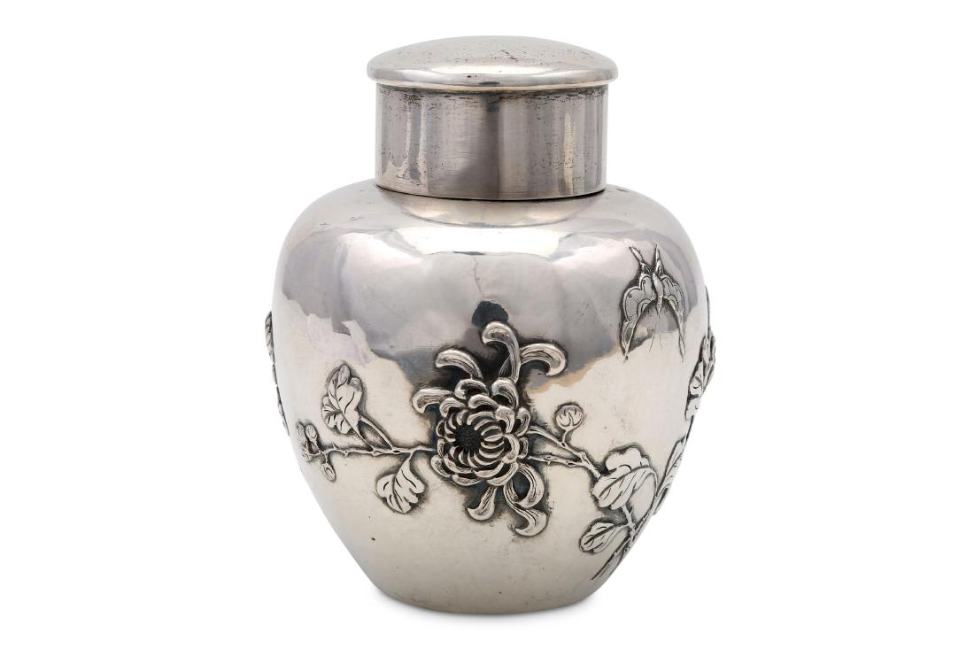 A SILVER TEA-CADDY.: A SILVER TEA-CADDY. Meiji period. Worked in uchidashi and engraving, with sprigs of flowering chrysanthemums, 11cm H. 銀製茶入れ *For a full condition repo