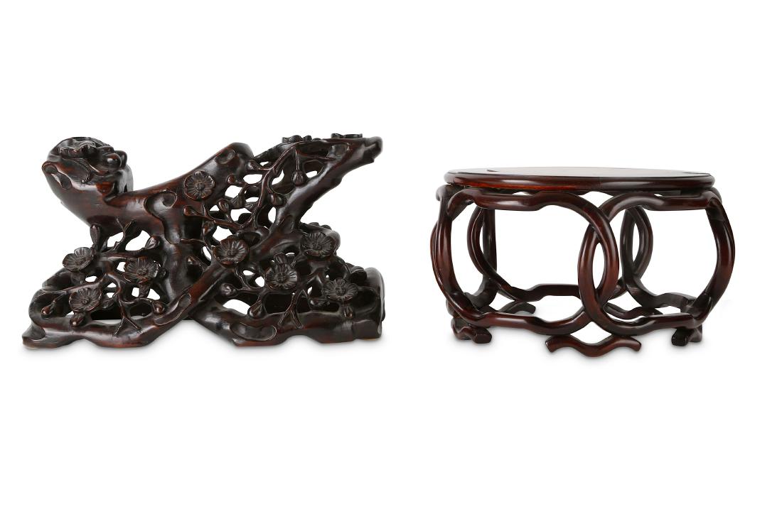 TWO CHINESE HONGMU STANDS.: TWO CHINESE HONGMU STANDS. 19th/20th Century. One a waisted stand for a carving with reticulated decoration of peach blossoms, the other with a circular inlaid top and tall sides carved as five connec