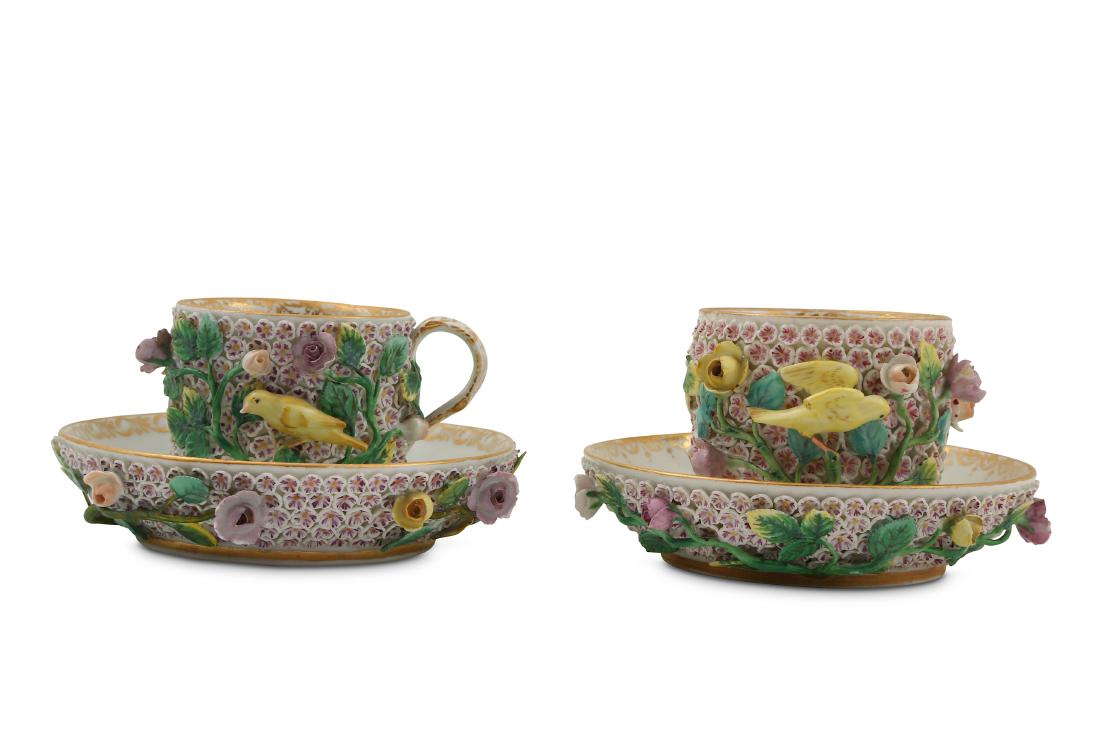 A pair of Meissen Schneeballen cabinet cups and: A pair of Meissen Schneeballen cabinet cups and saucers, circa 1890, each encrusted with pink and yellow flowers and stems, the cups with yellow birds, blue crossed swords marks to the underside (2)
