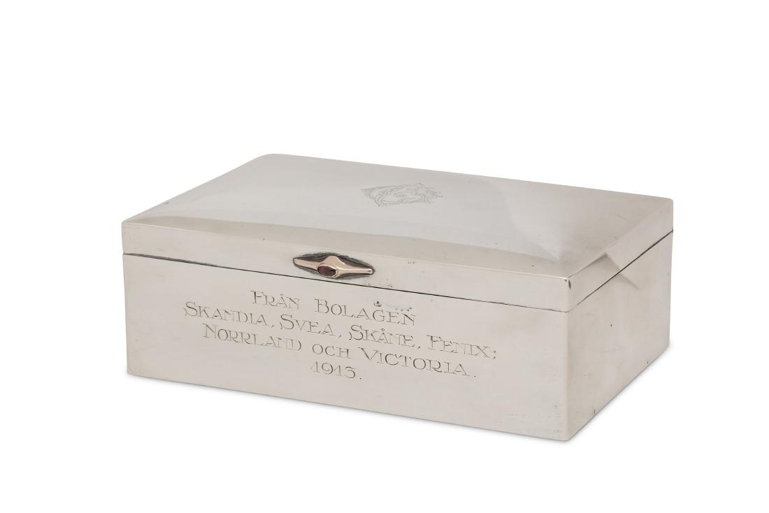 A Gustav V Swedish 830 standard silver cigar box,: A Gustav V Swedish 830 standard silver cigar box, Stockholm 1913 by Karl Andersson Of rectangular form, the unmarked rose gold thumbpiece inset with a sugar loaf cut garnet, the hinged lid engraved wi