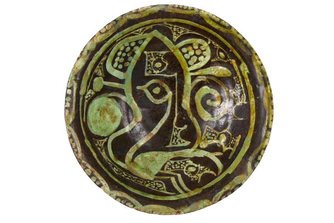 A BLACK AND WHITE SLIP POTTERY BOWL PROPERTY FROM THE: A BLACK AND WHITE SLIP POTTERY BOWL PROPERTY FROM THE STEPHEN KEYNES COLLECTION Nishapur, Iran, 10th century Of hemispherical shape, with rounded everted rim, on a short circular foot, the earthenware