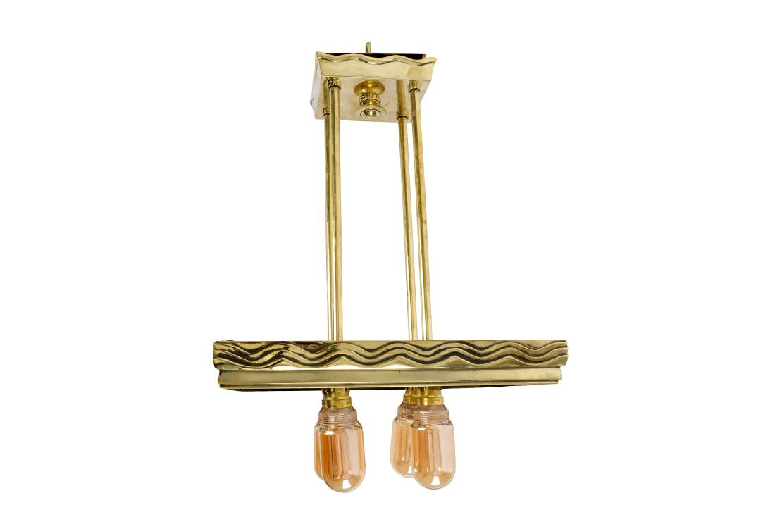 An Art Deco brass pendant light fitting: An Art Deco brass pendant light fitting, of rectangular form, with wavy detail, fitted with four bulbs, height 55cm x width 33cm x depth 24cm.