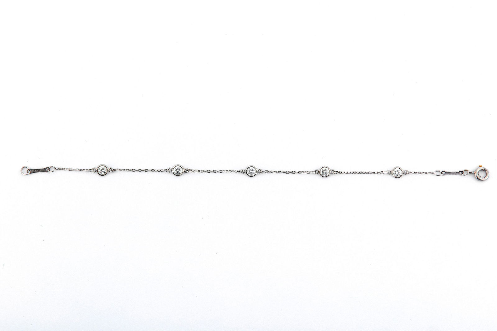 A 'Diamonds by the Yard' bracelet, by Elsa Perretti for: A 'Diamonds by the Yard' bracelet, by Elsa Perretti for Tiffany & Co., Spectacle-set with five brilliant-cut diamonds, mounted in platinum, signed Tiffany & Co. and Perretti, maker's mark T&Co., Londo