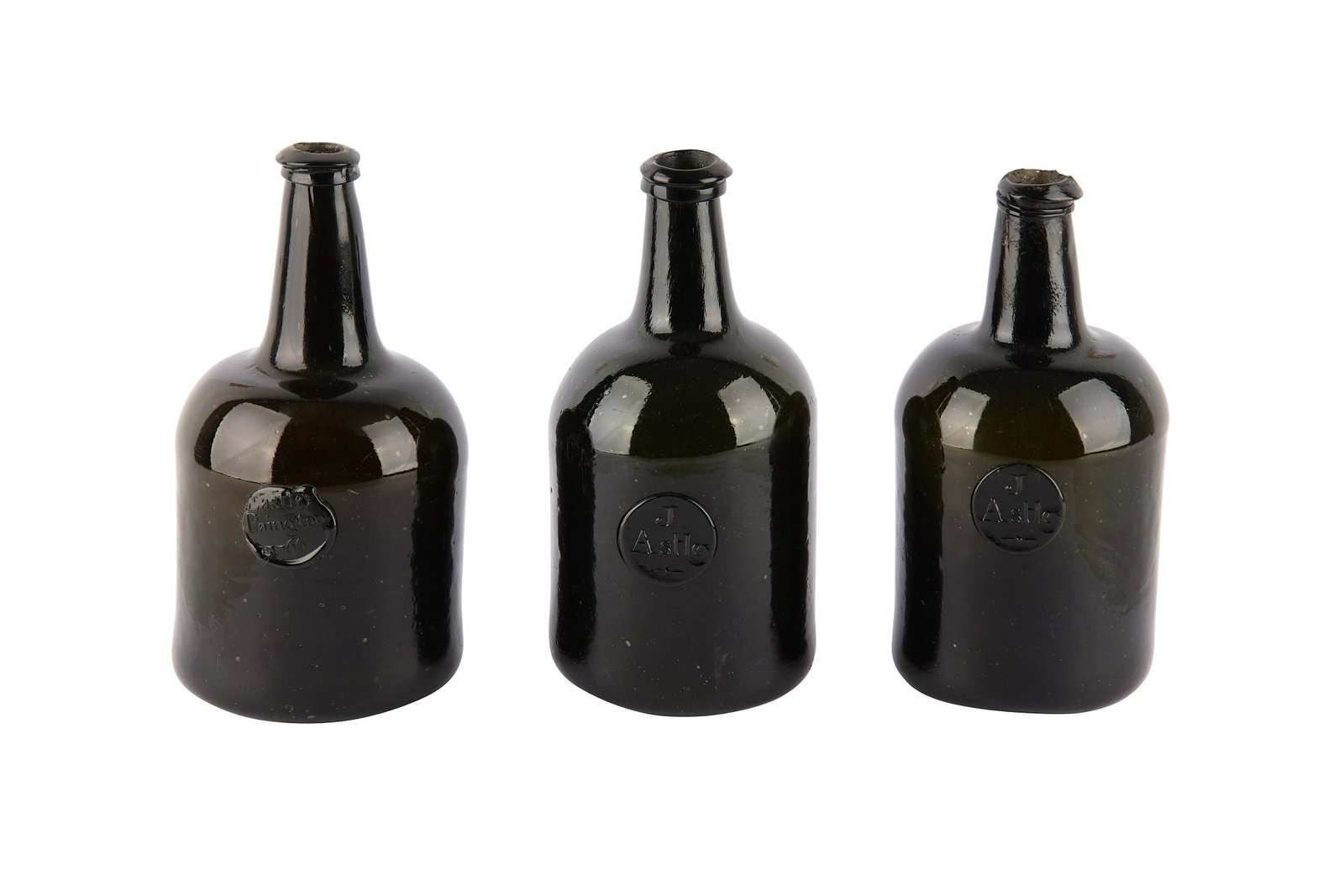 Three 18th Century English wine bottles, J Astley: Three 18th Century English wine bottles, dark olive green glass with applied seal mark, two stamped J Astley and one Paignton Lastely 1766, each of cylindrical shouldered form with tapering neck and h