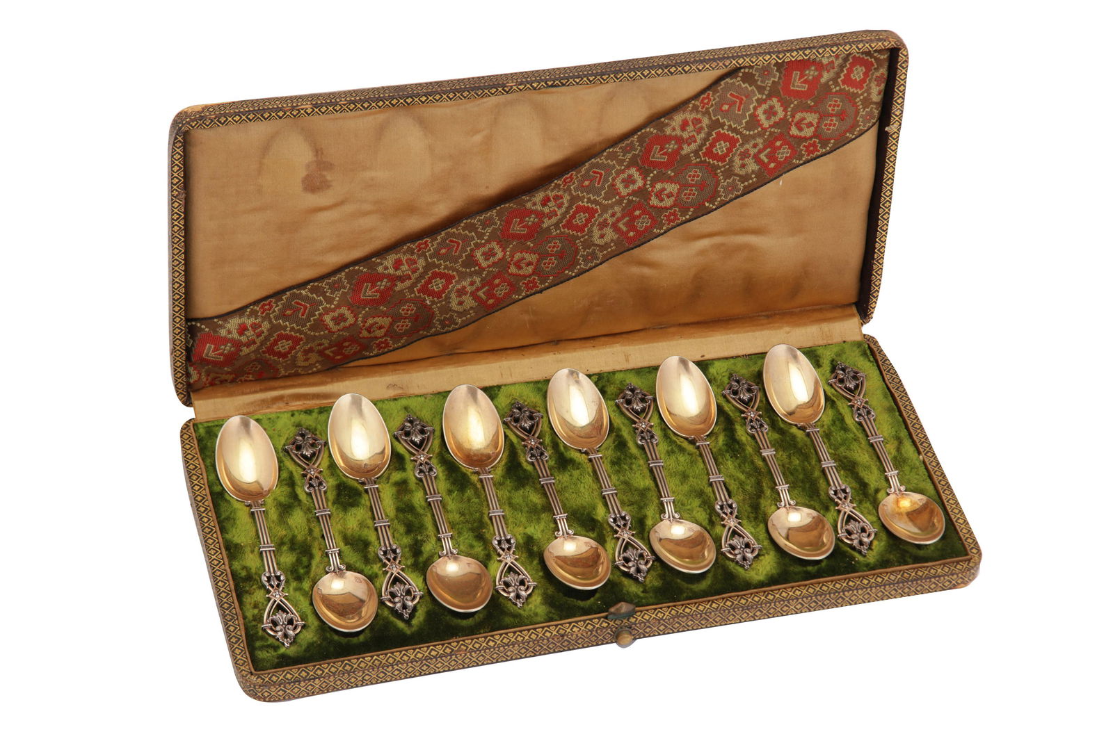 A cased set of twelve late 19th century French 950: A cased set of twelve late 19th century French 950 standard parcel gilt silver teaspoons, Paris circa 1890 by Alphonse Debain (active 1883-1911) With open work terminals with chased foliate sections,