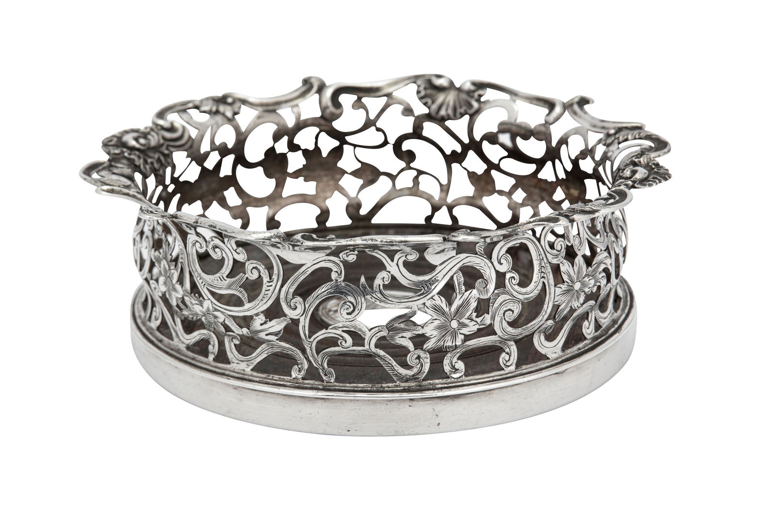 A Victorian sterling silver wine coaster, London 1841: A Victorian sterling silver wine coaster, London 1841 by Joseph Angell I & Joseph Angell II Circular form with shaped pierced sides of scroll work, the shaped rim with husk shells and rocaille. The in
