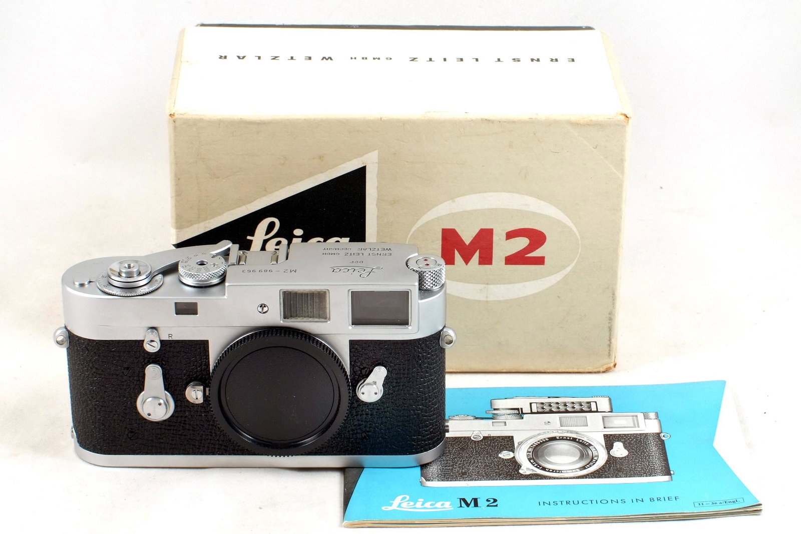 Boxed Chrome Leica M2 Rangefinder Body.: Boxed Chrome Leica M2 Rangefinder Body. #989963 (speeds all sound OK, signs of light use only) with aftermarket cap. In maker's box (shows slight wear) and with instruction book.