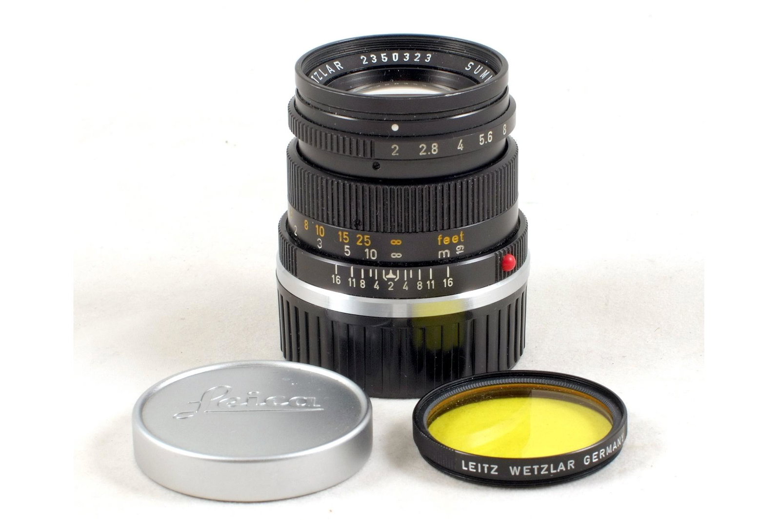 Rigid Black Leitz 50mm f2 Summicron M Lens.: Rigid Black Leitz 50mm f2 Summicron M Lens. #2350323, (signs of normal use with tiny coating spot to rear element). With chrome Leica front and replacement rear caps, fitted with a black Leitz yellow 