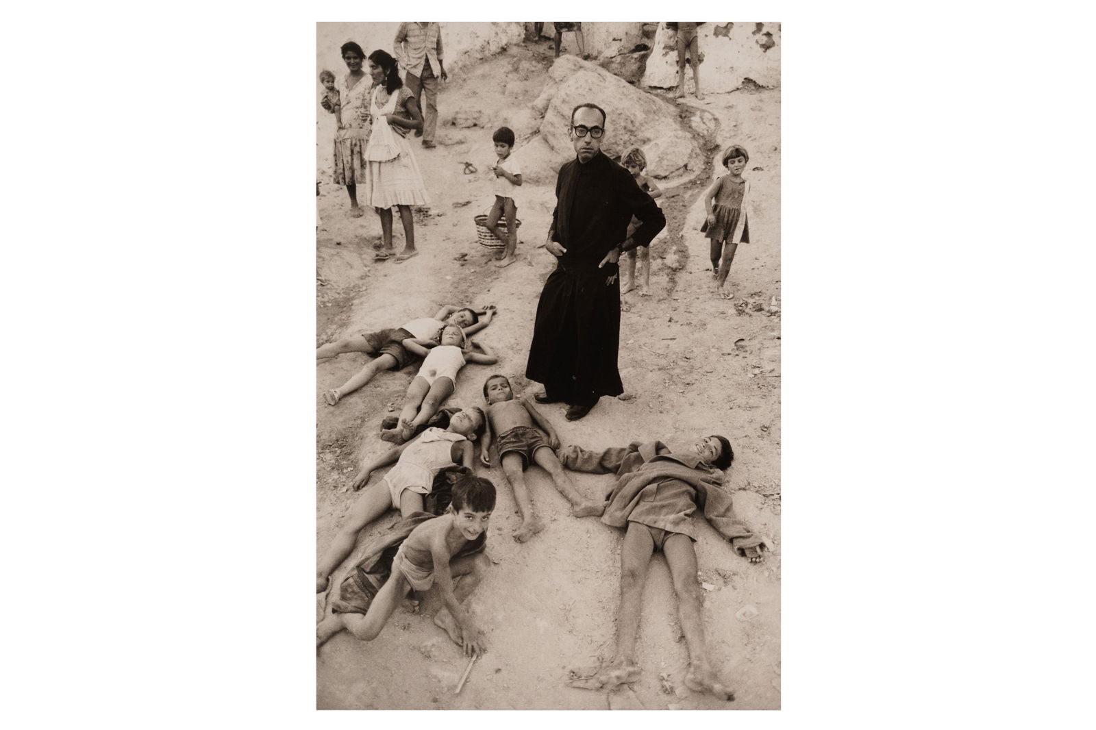 Bruce Davidson (b.1933): Bruce Davidson (b.1933) UNTITLED (PRIEST AMONG FALLEN CHILDREN), 1965. Silver gelatin print, image size, 250 x 205mm, photographer's copyright stamp verso, pencil annotations verso.
