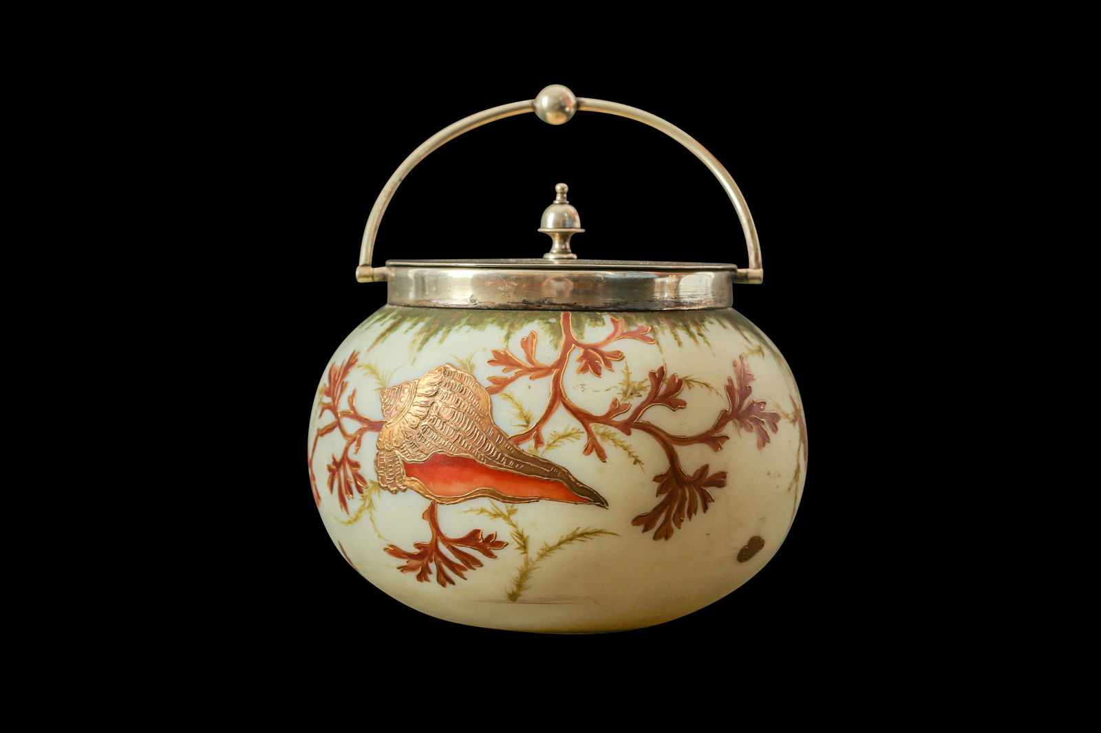A 19TH CENTURY BURMESE WARE GLASS BISCUIT BARREL IN THE: A 19TH CENTURY BURMESE WARE GLASS BISCUIT BARREL IN THE MANNER OF THOMAS WEBB & SONS the body painted with a sea shell and coral with gilt decoration, with silver plated swing handle and cover, 13cm h