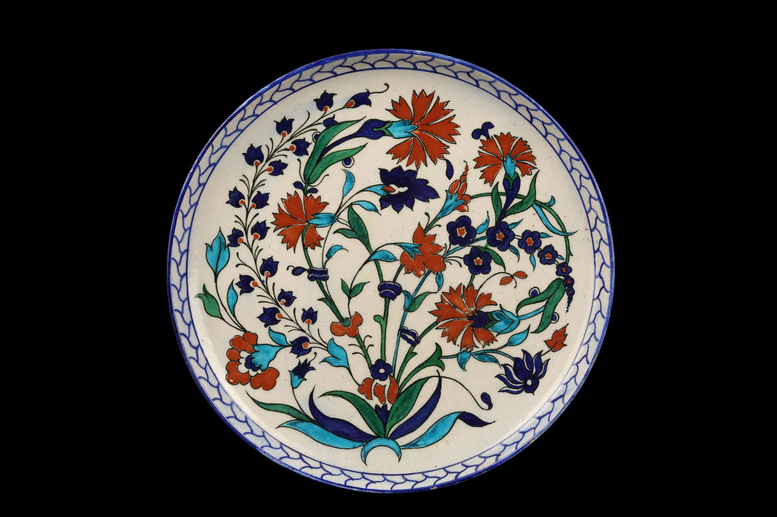 THEODORE DECK: A 19TH CENTURY GLAZED CERAMIC IZNIK: THEODORE DECK: A 19TH CENTURY GLAZED CERAMIC IZNIK STYLE DISH the circular plate decorated with a spray of carnations on a white ground, the reverse inscribed 'TD', 29cm diameter