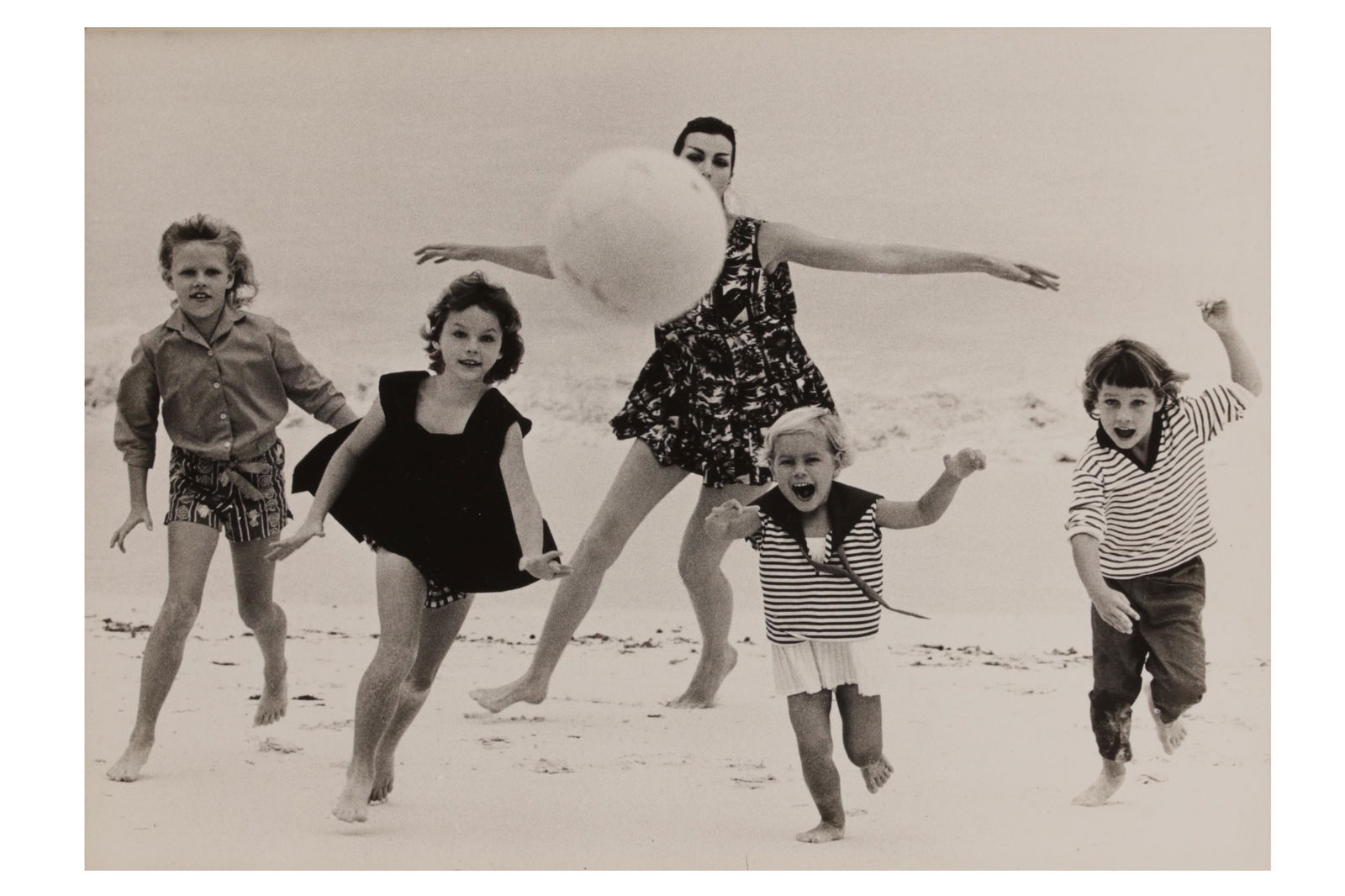 Norman Parkinson (1913-1990): Norman Parkinson (1913-1990) FAMILY BEACH PORTRAIT. Vintage silver gelatin print, image size, 370 x 260mm, flush-mounted onto board and window mounted with Angela Williams vintage print stamp recto. P