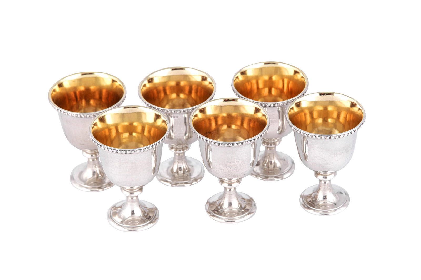 A set of six Victorian sterling silver egg cups, London: A set of six Victorian sterling silver egg cups, London 1866 by Hunt and Roskell Each of rounded form upon a circular pedestal foot, a beaded rim. Gilt interiors. Each fully marked near rim. (6) Heigh