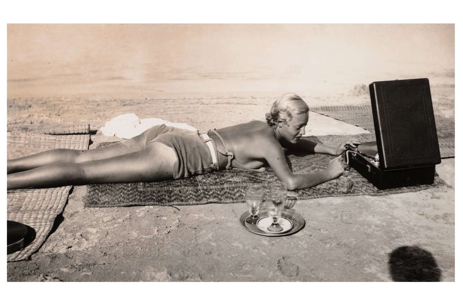 Jacques-Henri Lartigue (1894-1986): Jacques-Henri Lartigue (1894-1986) GIRL ON BEACH WITH RADIO, Cap dâ€™Antibes, France, 1932. Silver gelatin print, image size, 530 x 310mm, with the estate stamp verso and photographers blind stam