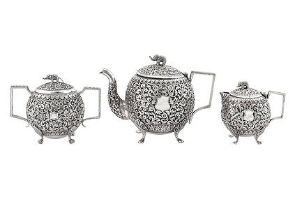 An assembled late 19th century Anglo – Indian unmarked silver three-piece tea service, Cutch circa (1 of 3)