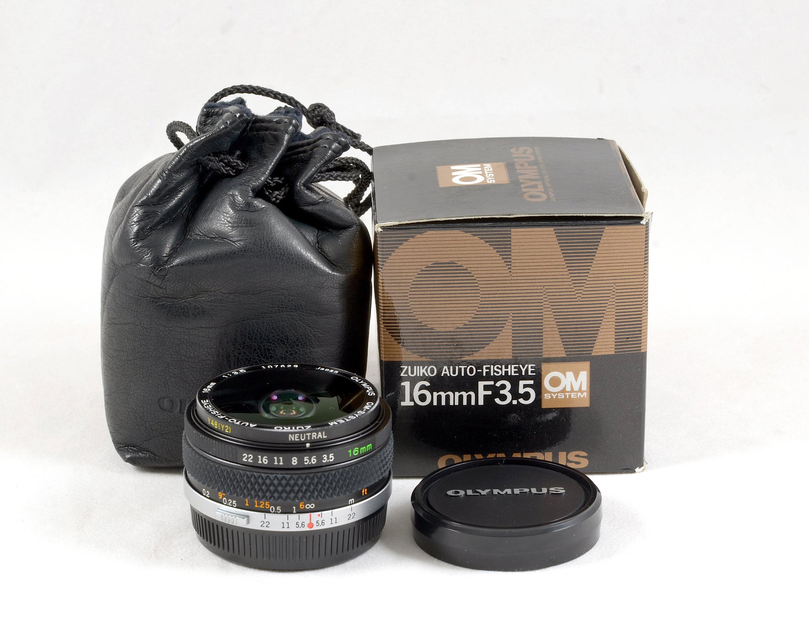 An Olympus OM Auto-Fisheye 16mm f3.5 Lens.: An Olympus OM Auto-Fisheye 16mm f3.5 Lens. #107629. With built-in filters, caps, case and in maker's box. Optics good with v minor internal dust etc. Signs of light use. Provenance: The John Foster Ol