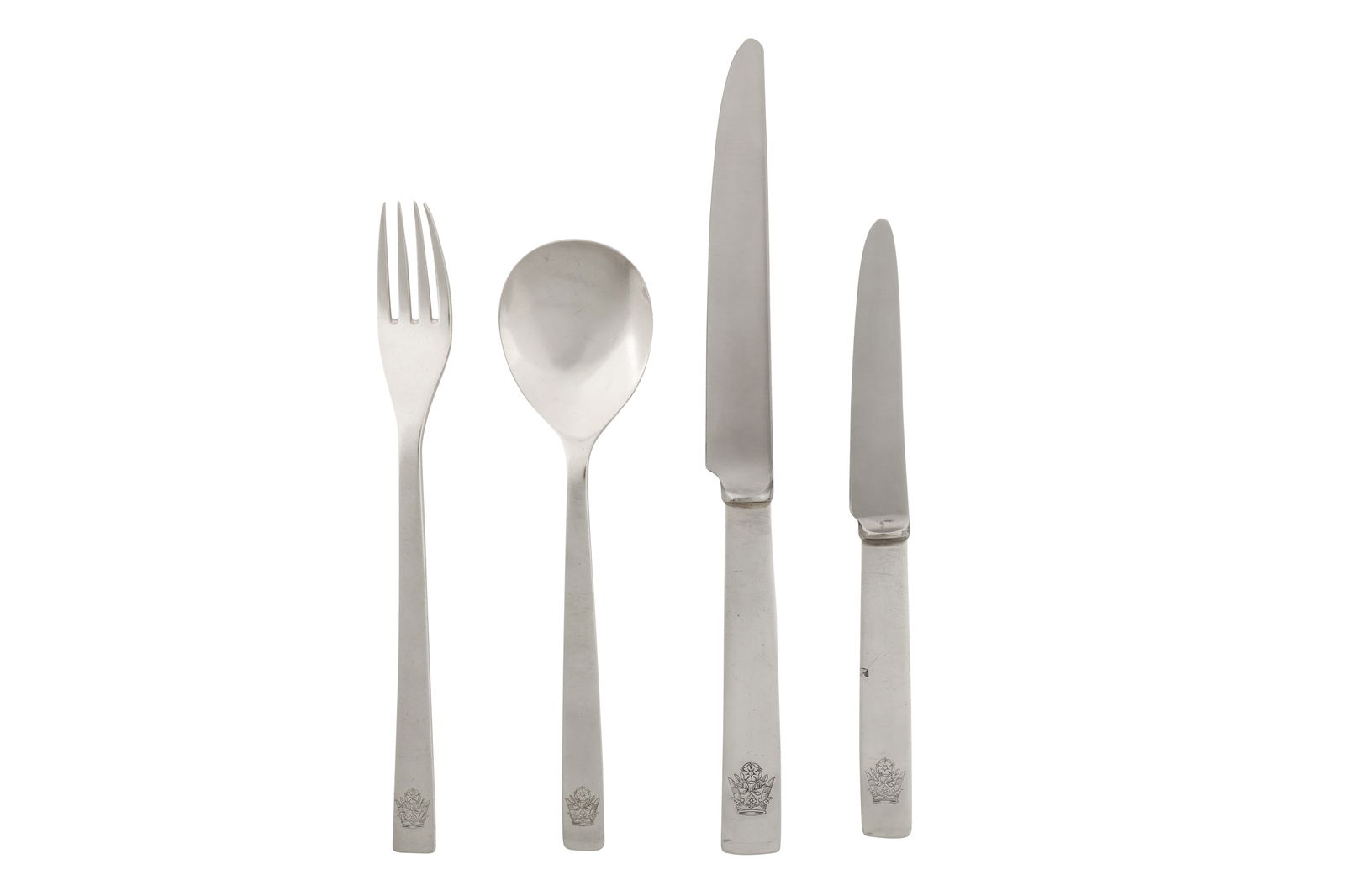 An Elizabeth II modernist sterling silver place setting, London 1966 by Gerald Benney (1930-2008): An Elizabeth II modernist sterling silver place setting, London 1966 by Gerald Benney (1930-2008) Comprising a tablespoon, a table fork, a table knife, and a side knife. Each engraved with a crest of
