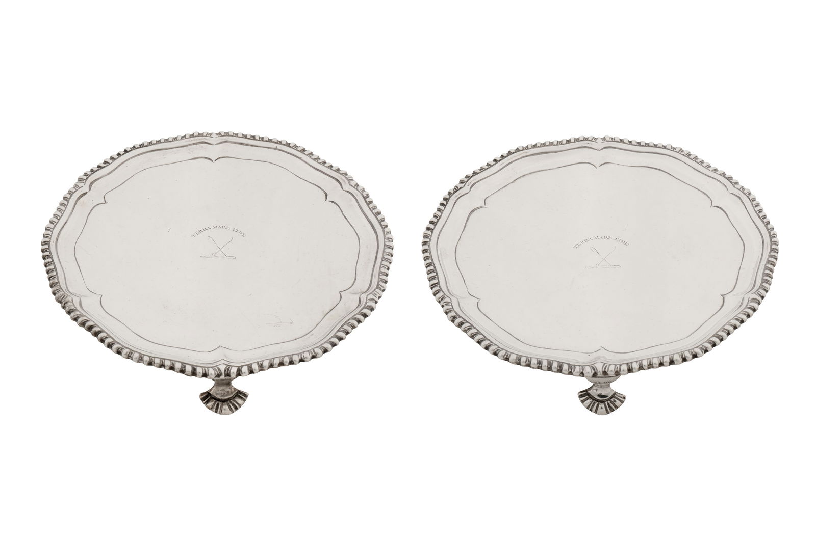 A pair of George III Scottish sterling silver waiters, Edinburgh 1773 by Alexander Gardner: A pair of George III Scottish sterling silver waiters, Edinburgh 1773 by Alexander Gardner Of shaped circular form with a shaped cavetto edge and a gadrooned rim, each raised upon three gadrooned pad