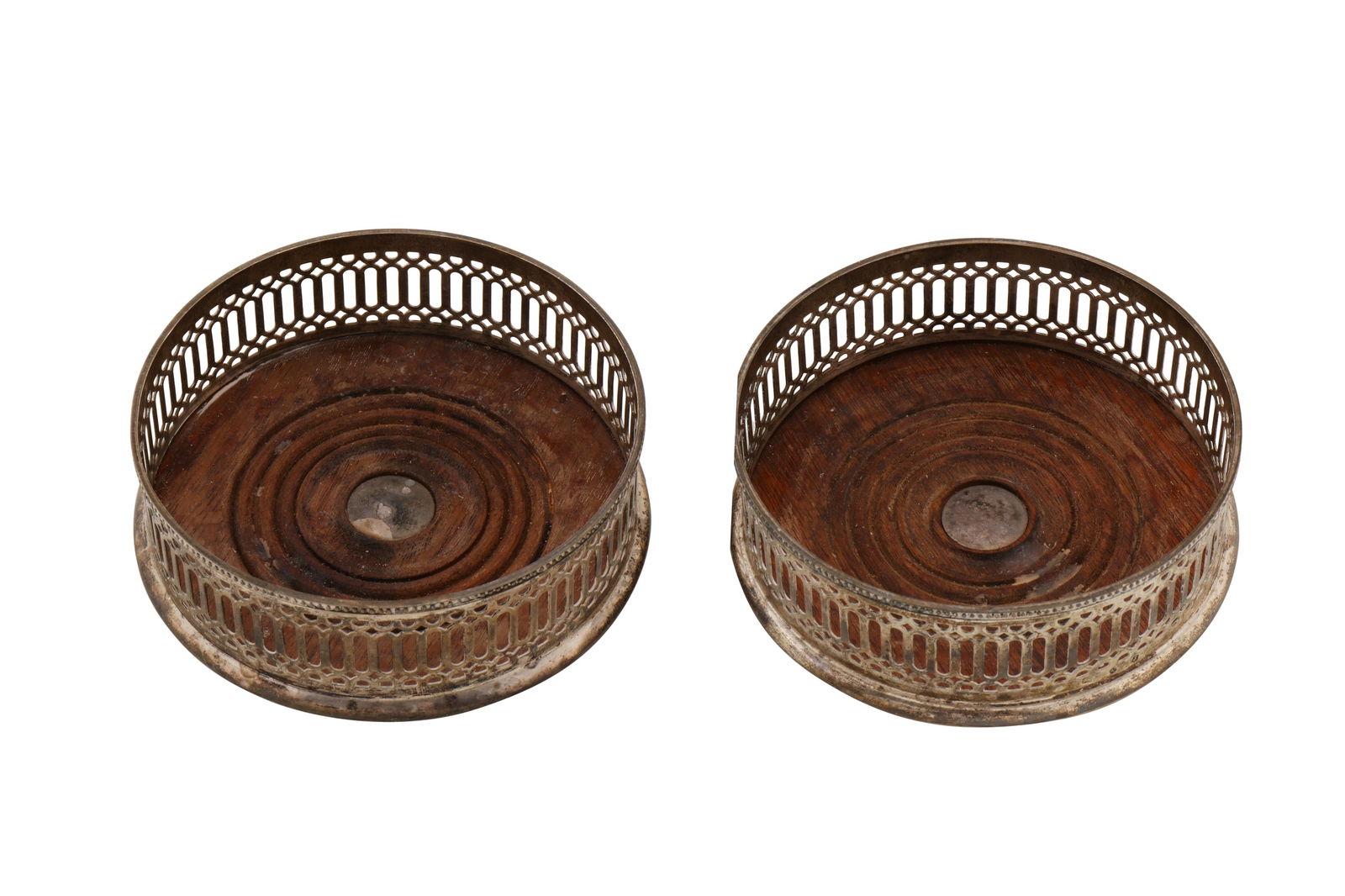 A pair of Elizabeth II sterling silver wine coasters, London 1972 by Mappin and Webb: A pair of Elizabeth II sterling silver wine coasters, London 1972 by Mappin and Webb In the George III style. Each with wooden bases and pierced sides. (2) Diameter – 12.7 cm / 5 inches