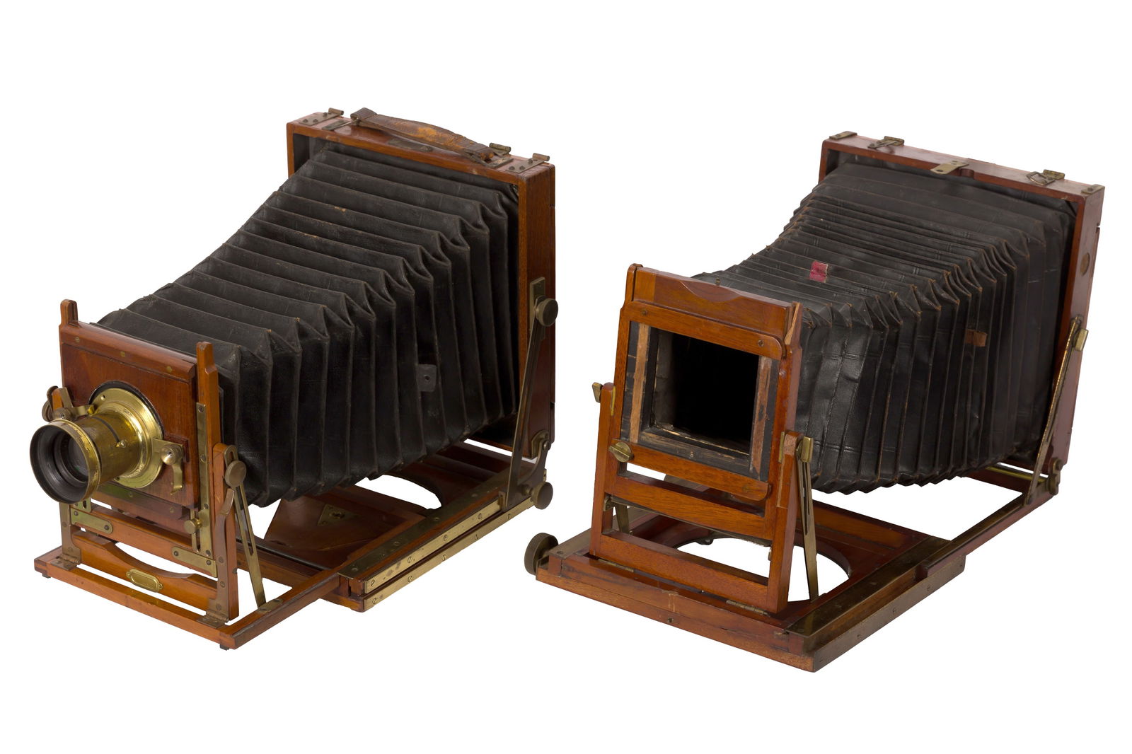 A Pair of Half Plate Field Cameras: A Pair of Half Plate Field Cameras A City Sale & Exchange "Triple Diamond" Houghtons Mahogany Field CameraBody: triple extension mahogany and brass, tapered black leather bellows, small loss to gr