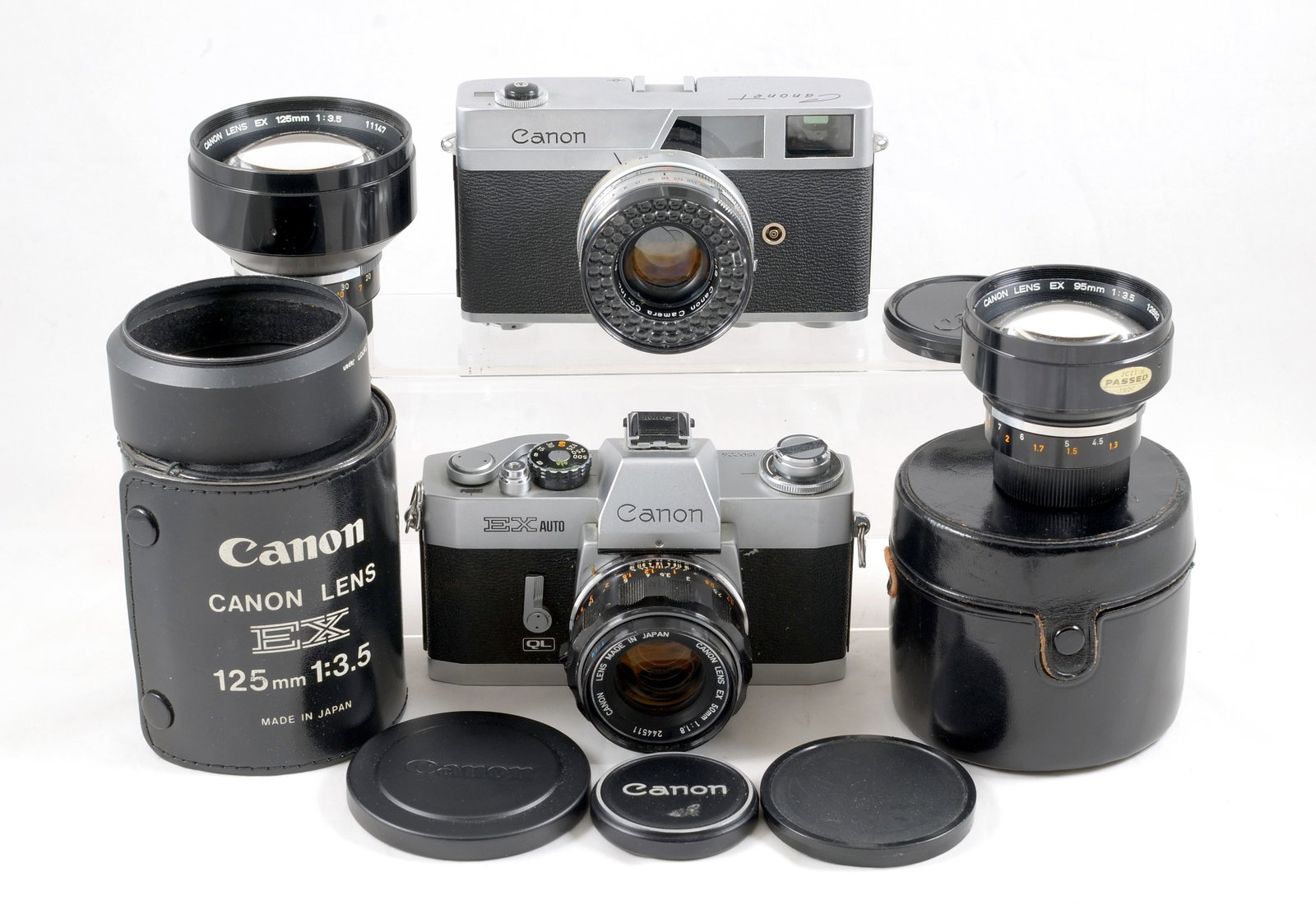 Canon EX Auto Outfit & a Canonet.: Canon EX Auto Outfit & a Canonet. Comprising an EX body #150224 shutter firing, meter not responding (signs of normal use) with EX 50mm f1.8, EX 90mm f3.5 & EC 125mm f3.5 lenses. Also a trigge