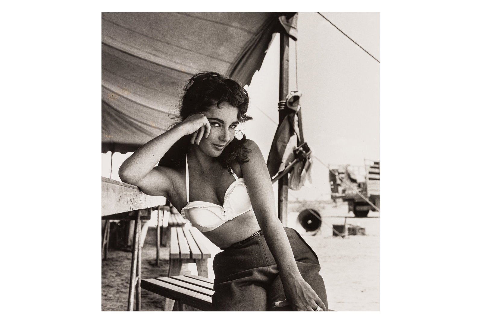 Frank Worth (1923-2000): Frank Worth (1923-2000) ELIZABETH TAYLOR ON THE SET OF "GIANT", 1955. Silver gelatin print, printed later, image size 405 x 375mm, sheet size 505 x 405mm, with the photographer's posthumous blindstamp