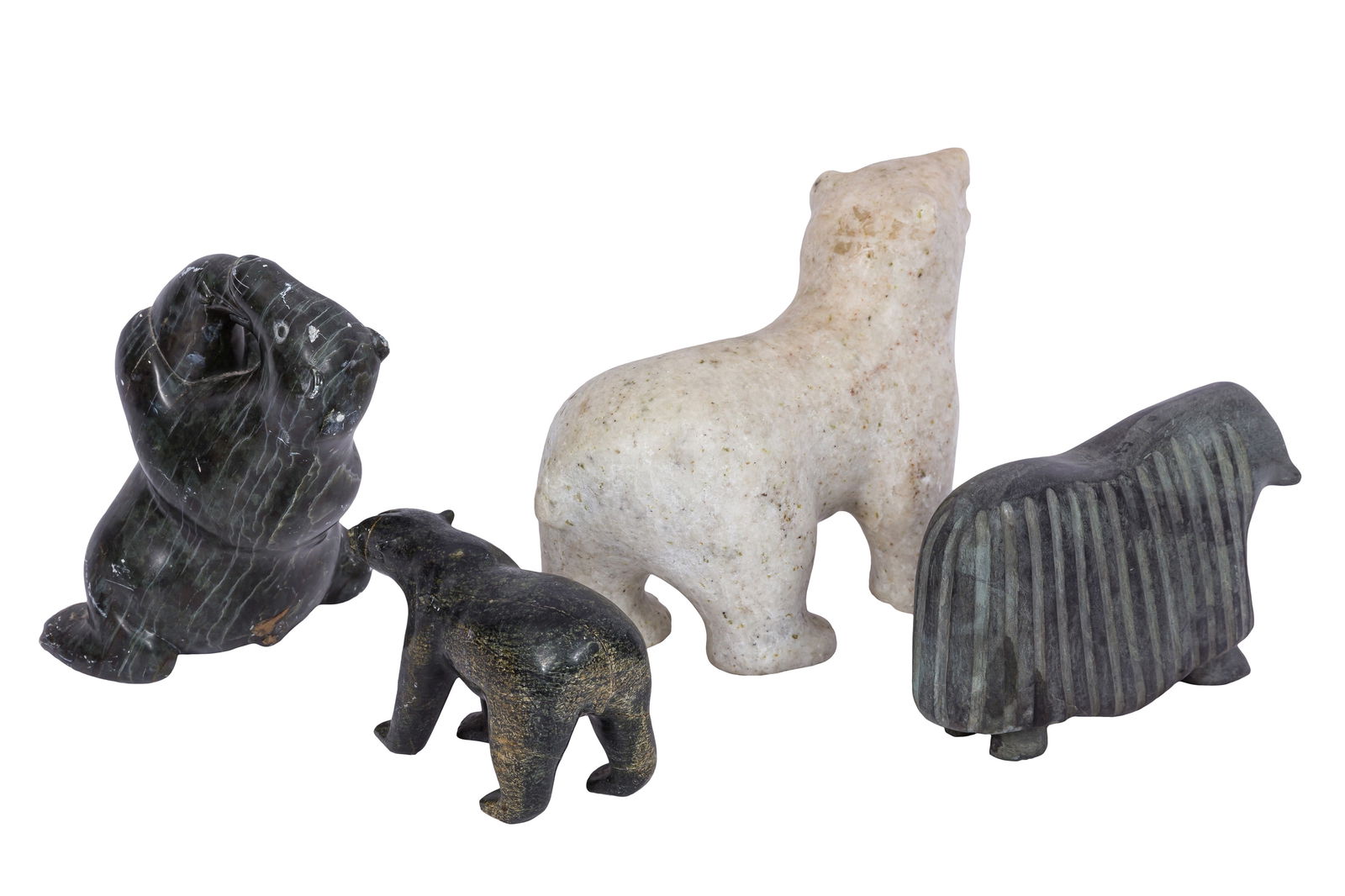 AN INUIT CARVED STONE SCULPTURE, MID 20TH CENTURY, CANADA: A GROUP OF FOUR INUIT CARVED STONE SCULPTURES, MID 20TH CENTURY, CANADA, including; one by Qaunaq Palluq (1936-2002) Clyde River (Kanngiqtugaapik), depicting a standing polar bear devouring a seal, be