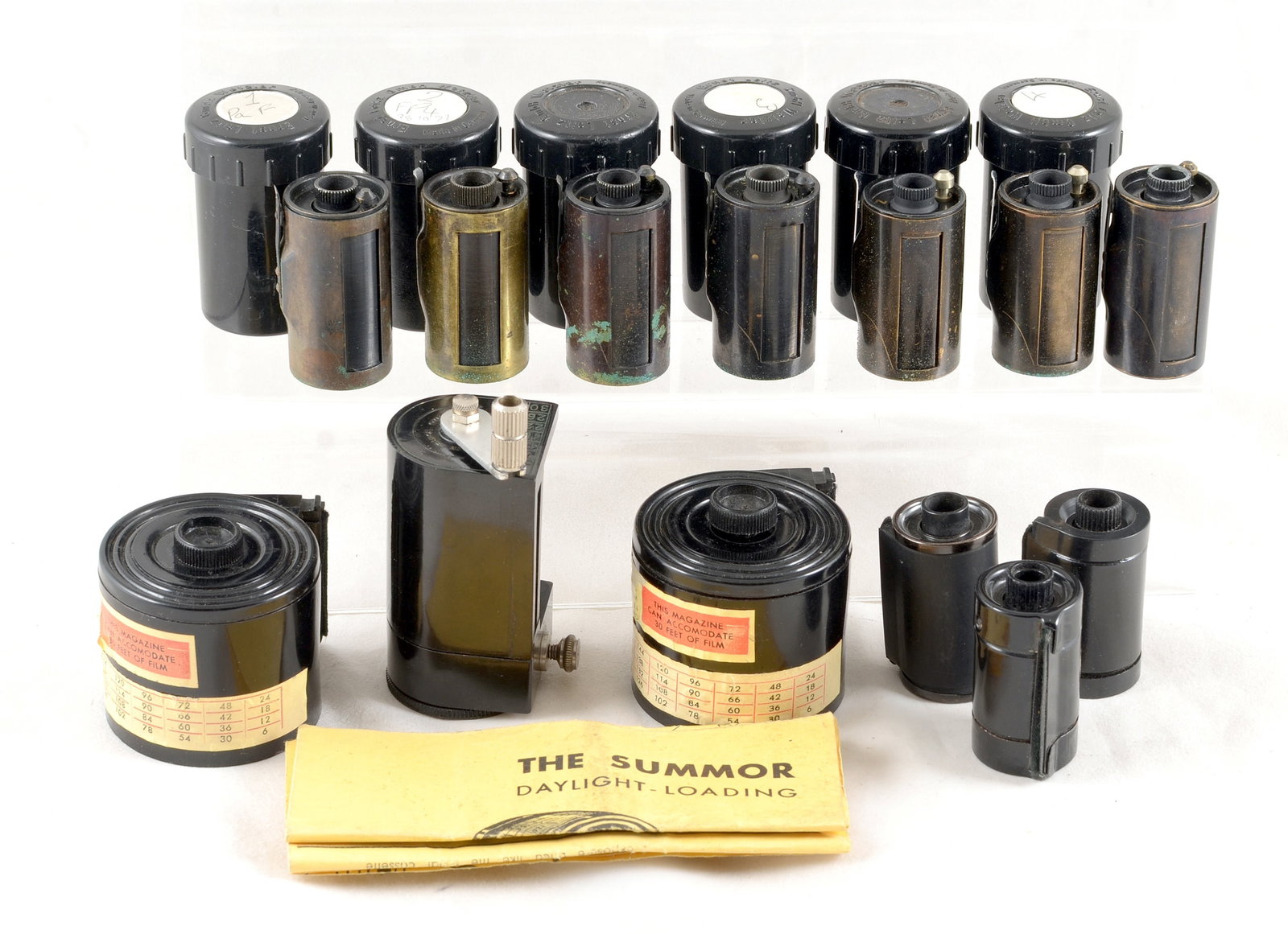 Seven Leitz Reloadable Film Cassettes & a Summor Loading Set.: Seven Leitz Reloadable Film Cassettes & a Summor Loading Set. Comprising seven Leitz reloadable 35mm film cassettes for Leica cameras, six with keepers and a Summor Daylight - Loading set with two cas