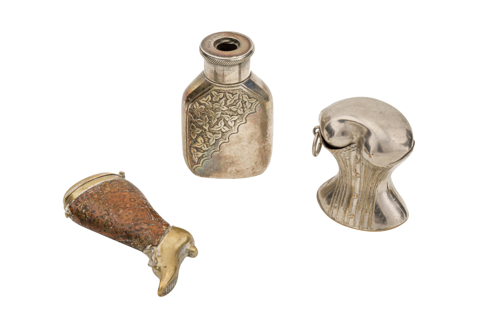 A group of three early 20th century novelty base metal vesta cases: A group of three early 20th century novelty base metal vesta cases Including a german base metal and leather novelty vesta case, formed as a ladie's boot by Depornit, a 'The maze Morton's pattent' ves