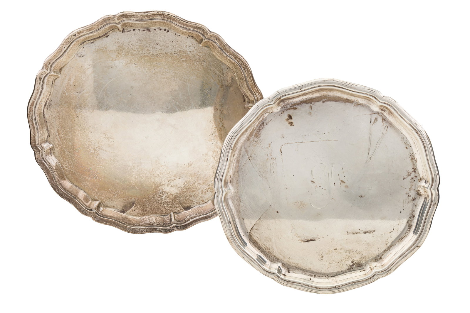 Two George V sterling silver salvers: Two George V sterling silver salvers Each of shaped circular form. Fully marked. One with traces of an engraved initial. (2) Largest diameter – 25.5 cm / 10 inches Weight – 807 grams / 25.